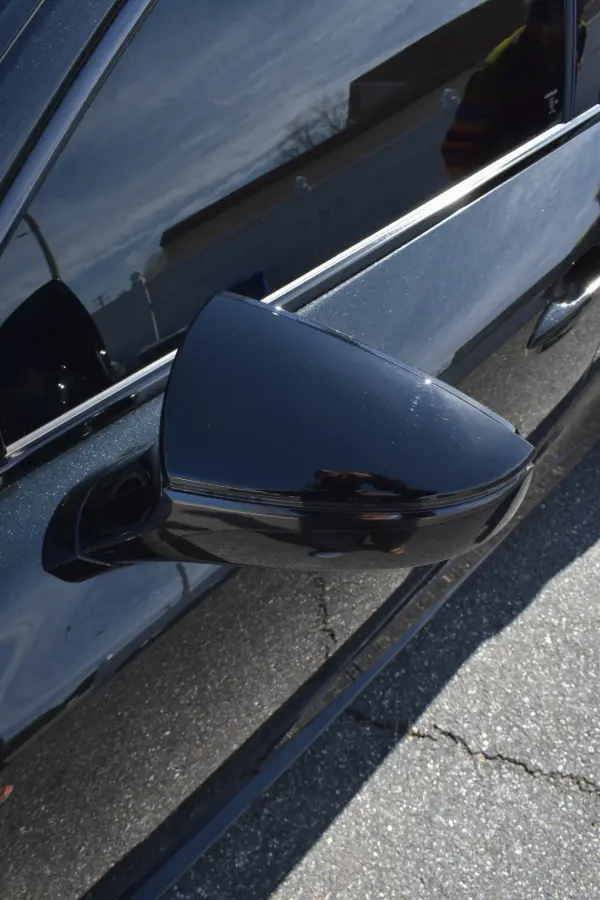 Black side mirror and chrome window trim, polished