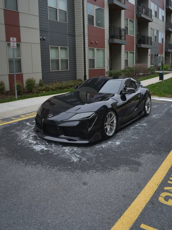 The black Supra finished and gleaming, parked where it was detailed