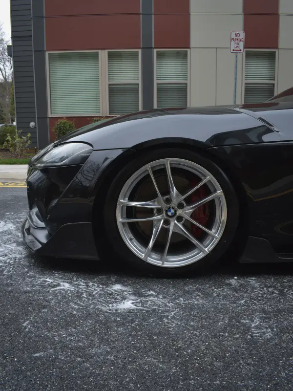 Supra wheel and red brake caliper washed down